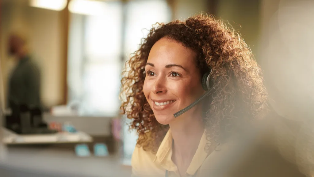 Customer service representative with strong communication skills answering customer needs with a positive attitude