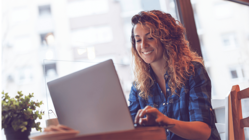 A photo of an experienced virtual assistant working from a library or a cafe