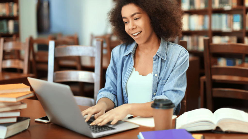 A photo of an experienced virtual assistant working from a library or a cafe