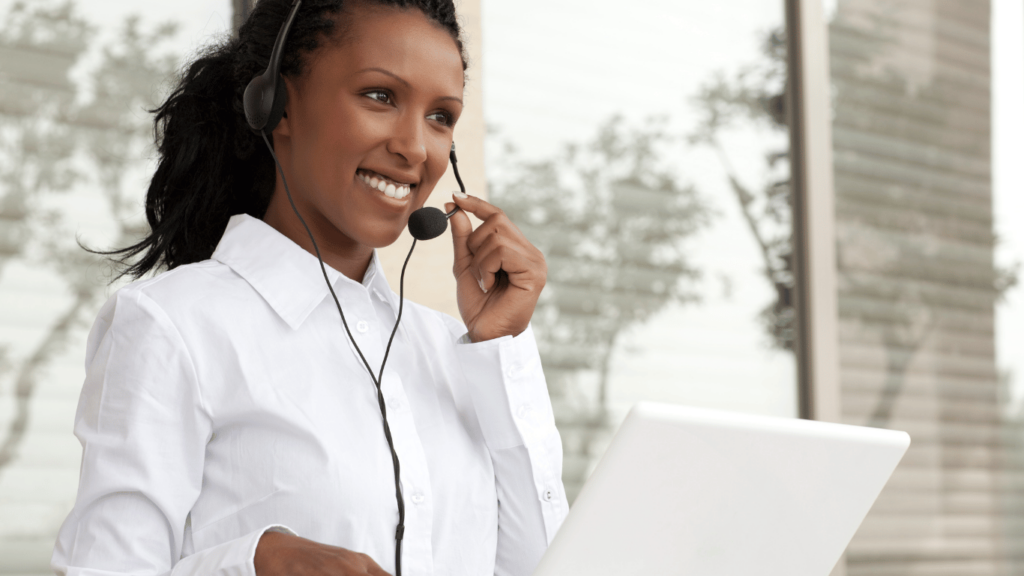 An image showing a customer service representative on a headset, representing the advantages of outsource customer service