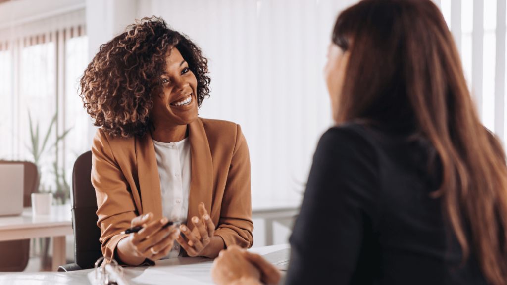 A customer service agent catering to customers from a desk