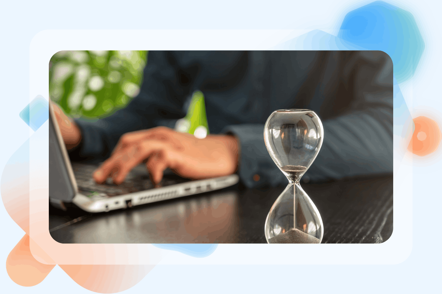 Technician busy at work with an hourglass beside him to symbolize time